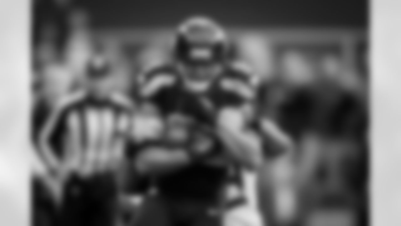 Seattle's Doug Baldwin fiercely protects the ball as he fights for extra yards down to the Green Bay 35-yard line after his clutch catch on third down set up Seattle's game-winnng touchdown.
