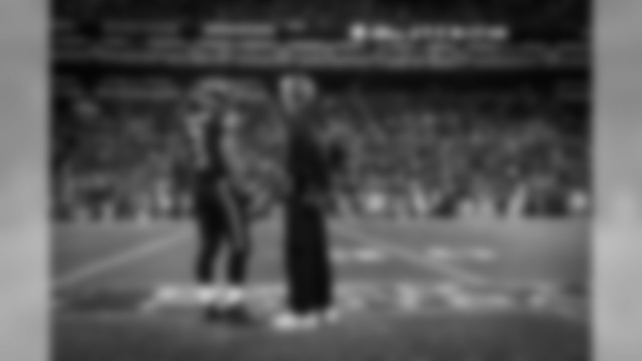 Quarterback Russell Wilson and head coach Pete Carroll share a moment on the field during the two-minute warning with the game safely in hand.