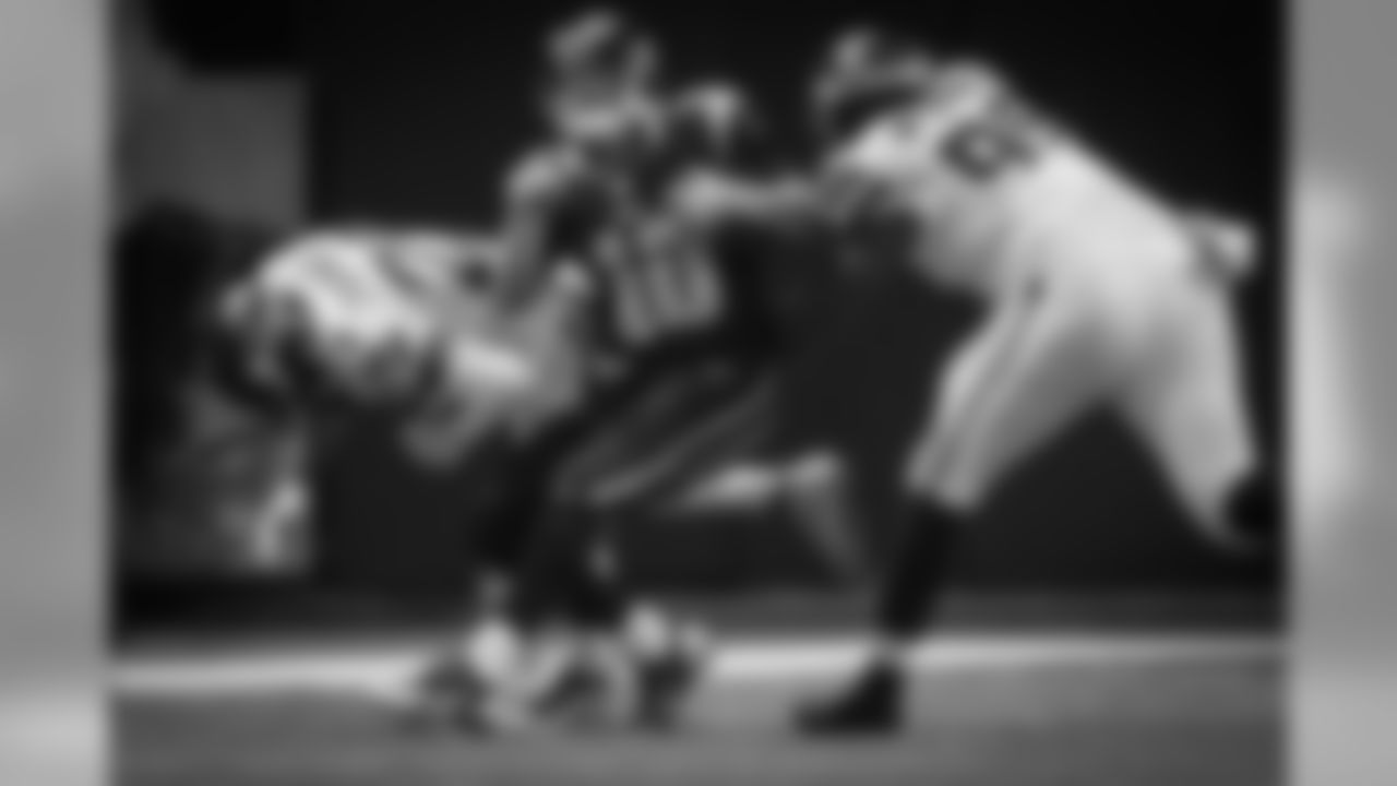 St. Louis quarterback Kellen Clemens is spun around after a hard hit by Seattle's Earl Thomas as Tony McDaniel comes in to assist.