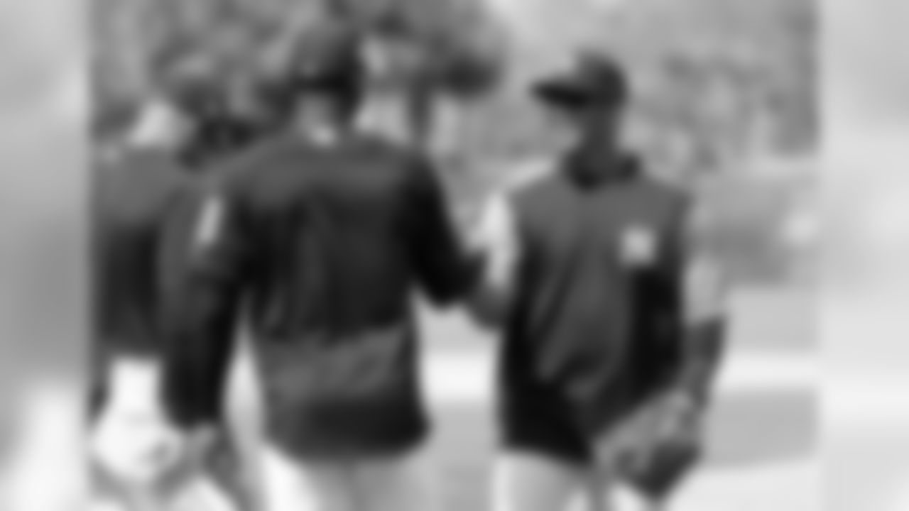 Seattle Seahawks NFL football team quarterback Russell Wilson, right, shakes hands with shortstop Didi Gregorius (18) at New York Yankees baseball spring training camp, Monday, Feb. 26, 2018, in Tampa, Fla. (AP Photo/Lynne Sladky)