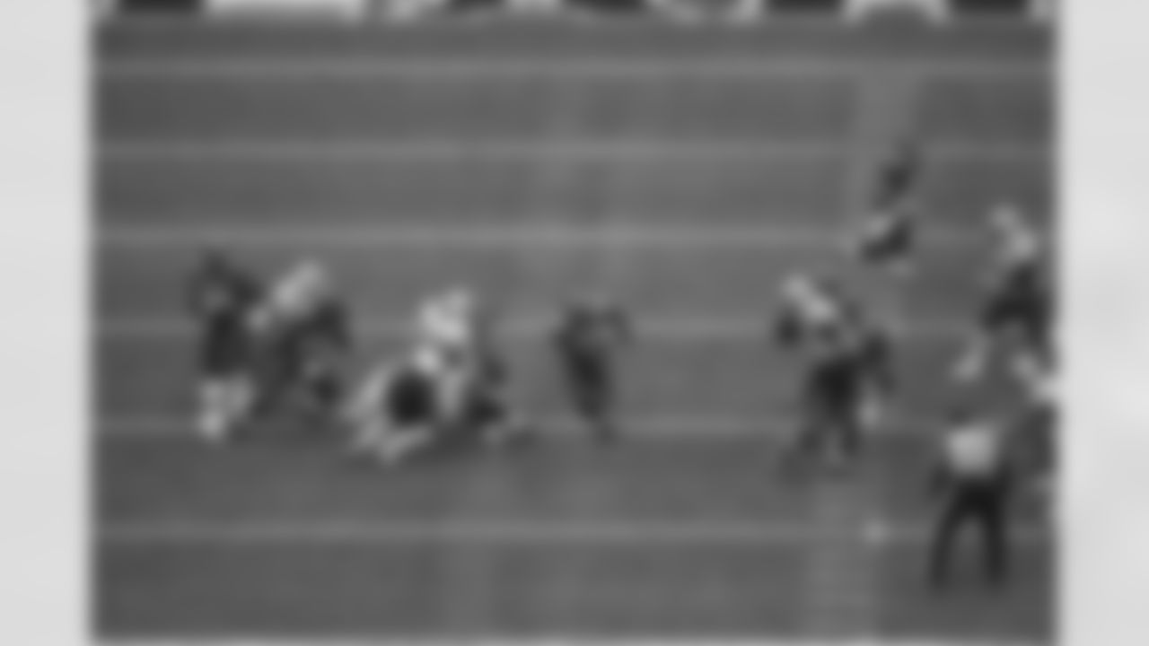 Leonard Weaver busts a run up the middle of the Patriots defense.