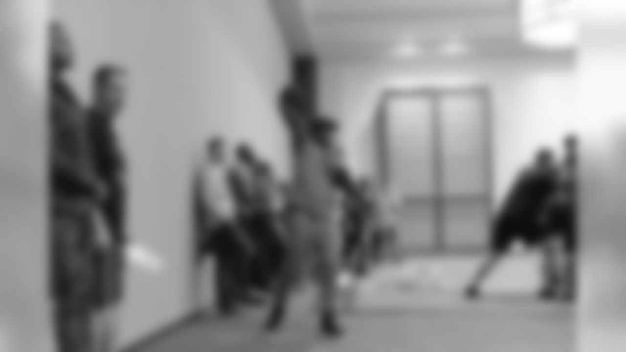 Quarterback Russell Wilson throws a pass during the offensive unit's brief walk thru in a hotel ballroom.