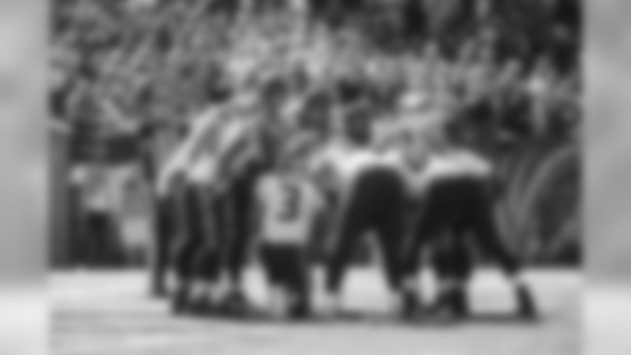 The Seahawks huddle in their own end zone.