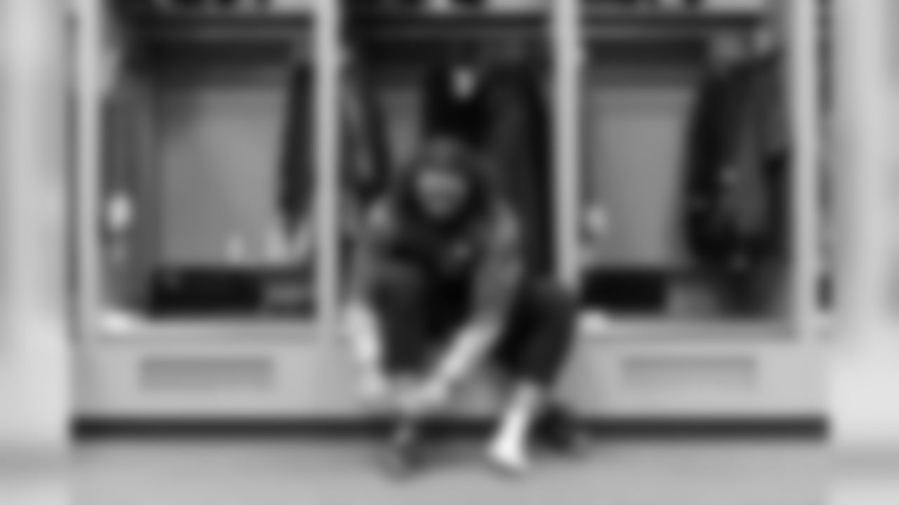 New Seahawks fullback Will Tukuafu laces up his shoes in the locker room, ready to make his debut in front of the 12th Man.
