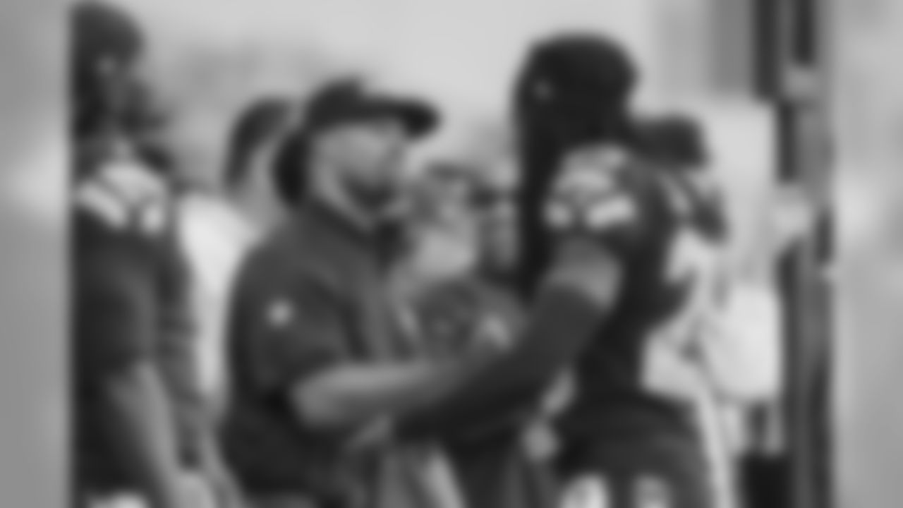 Seahawks assistant coach Kris Richard receives congratulations from Richard Sherman after the Richard coached his first victory and shutout since being named defensive coordinator.