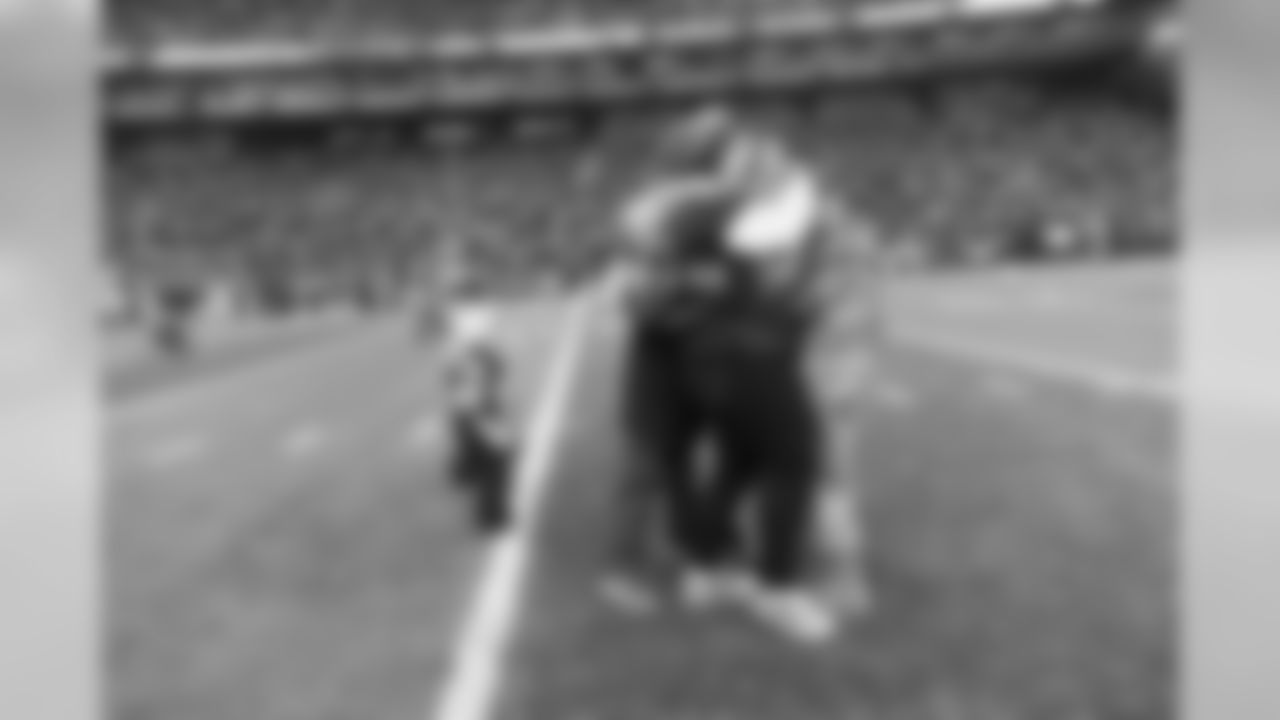 The family of U.S. Army Sergeant Scott Young mobs him on the field during halftime as he is reunited with them for the holidays before returning to his deployment in Iraq.