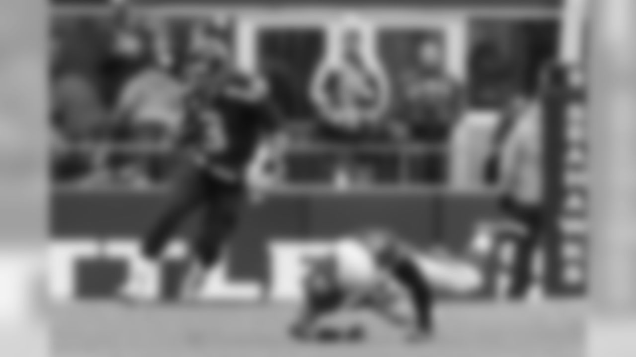 Russell Wilson dances his way upfield, scrambling away from Arizona's Josh Mauro.