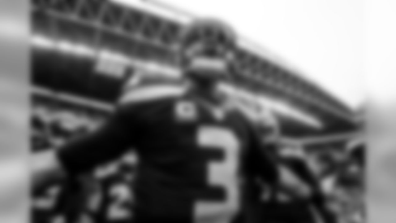 Quarterback Russell Wilson gathers the team on the field for a brief pep talk before pregame warmups.