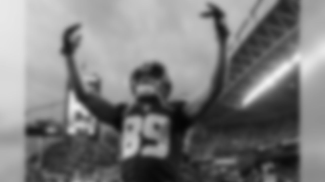 Receiver Doug Baldwin exhorts the crowd as players returned to the field.