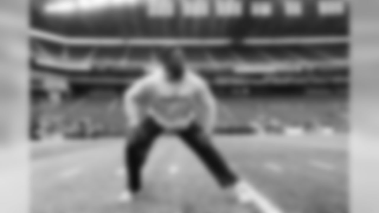 Germain Ifedi stretches on the field before the start of the game.