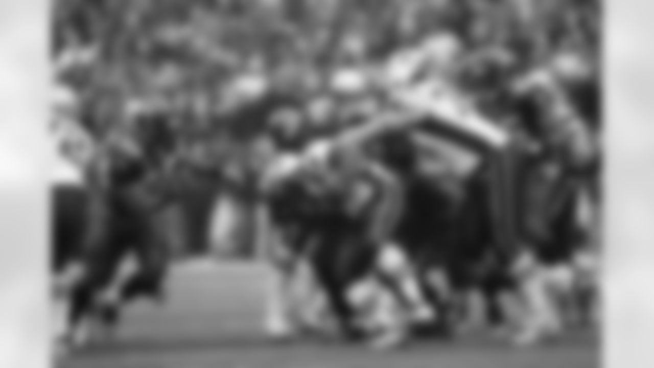 Rocky Bernard fights through a block to stuff a running play.