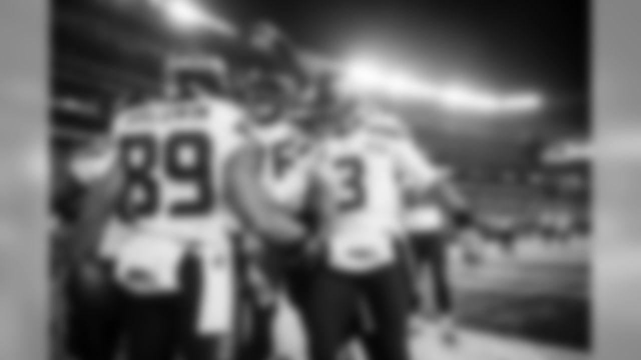 Wide receiver Doug Baldwin is congratulated by teammates Russell Okung and Russell Wilson after his touchdown capped the scoring, making it 43-8.
