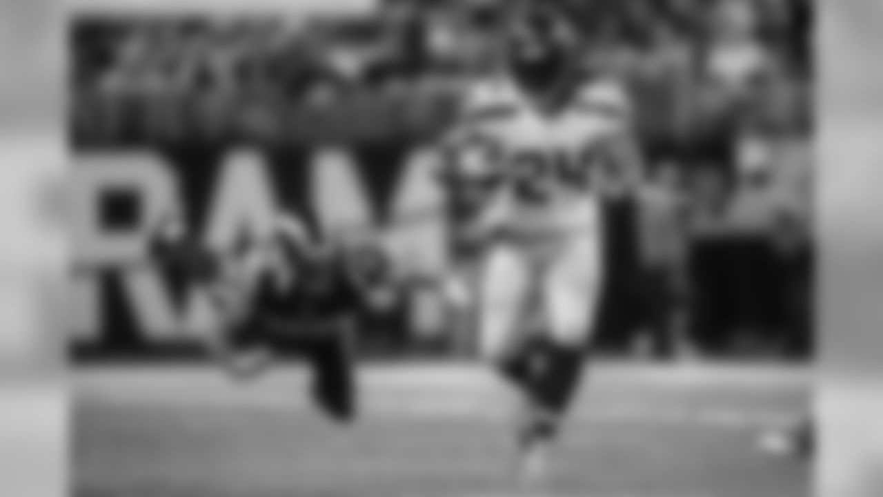 Marshawn Lynch sprints away from diving St. Louis defender T.J. McDonald during the second quarter.