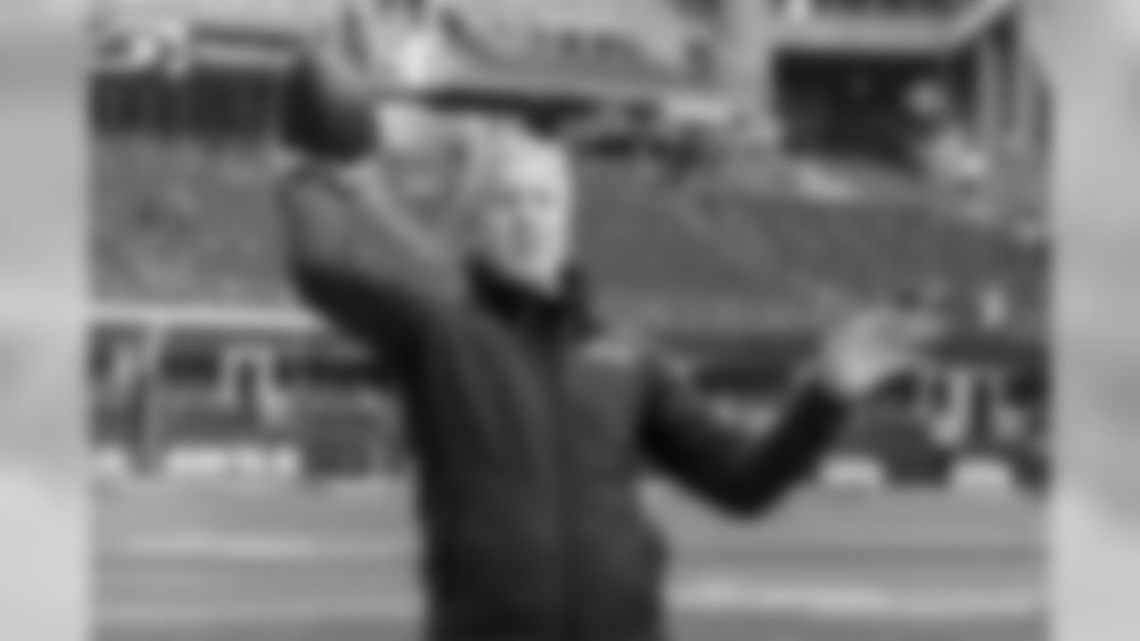 Head coach Pete Carroll plays catch before the players arrive on the field for early warmups.