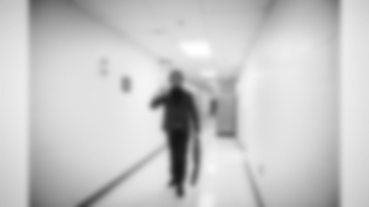 Walking alone along a back corridor of the hotel, safety Earl Thomas flashes the "Legion of Boom" sign as he makes his way to the bus.
