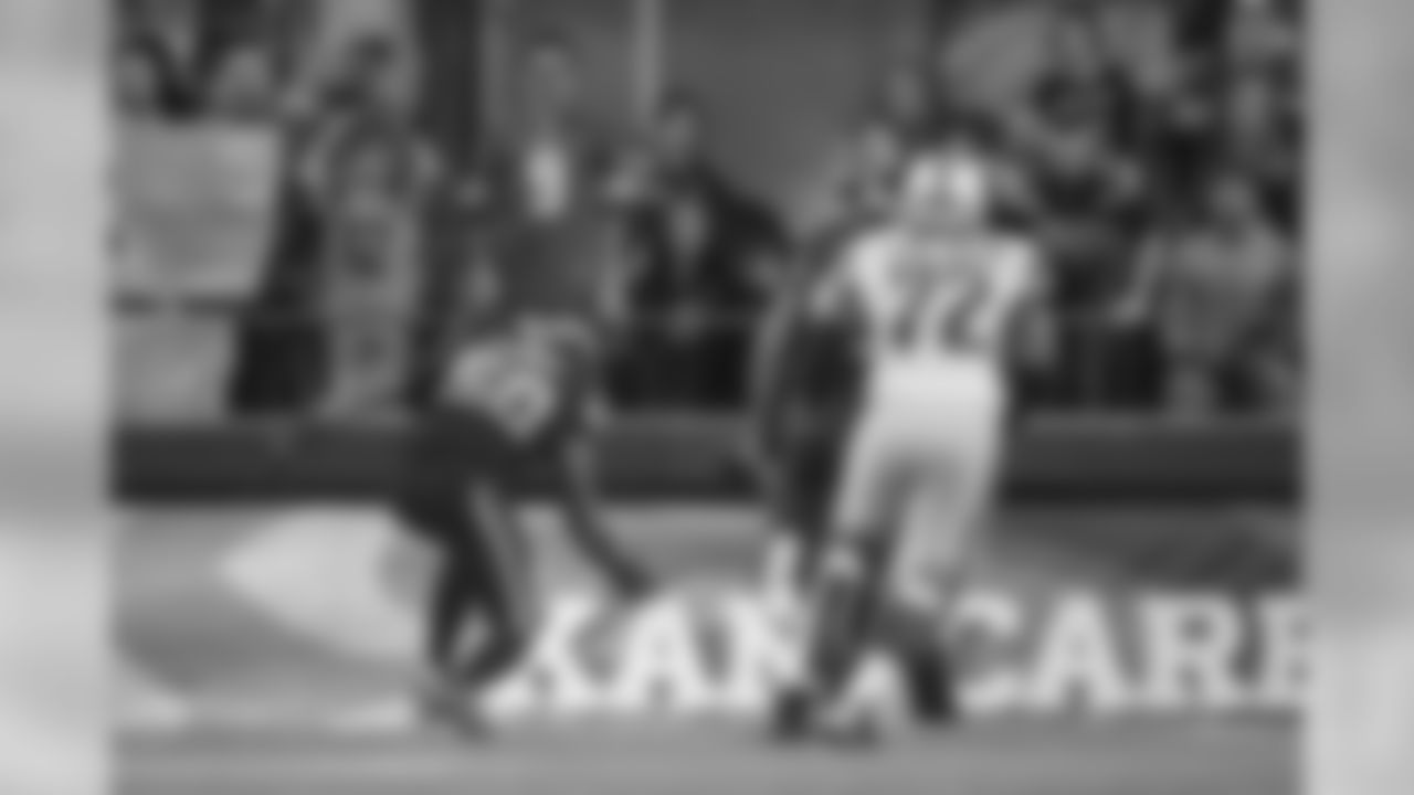 Seattle's K.J. Wright reaches towards the loose ball in the end zone as fans of both the Seahawks and Lions react to the game-changing play.