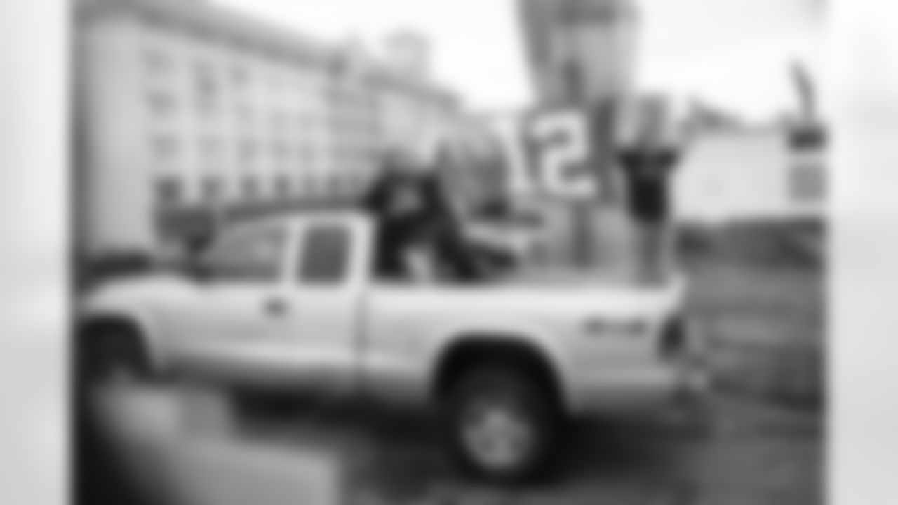 Fans used their truck bed as a riser as they proudly displayed a 12 flag as the team buses passed on the way into the airport for the trip to San Jose where the team was based for the game in Santa Clara.