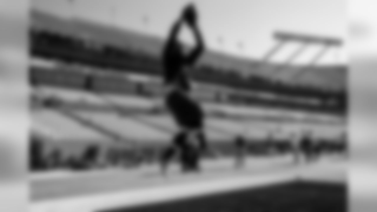 Receiver Doug Baldwin leaps high as he goes through his game day ritual of early warmup with teammate and friend Richard Sherman.