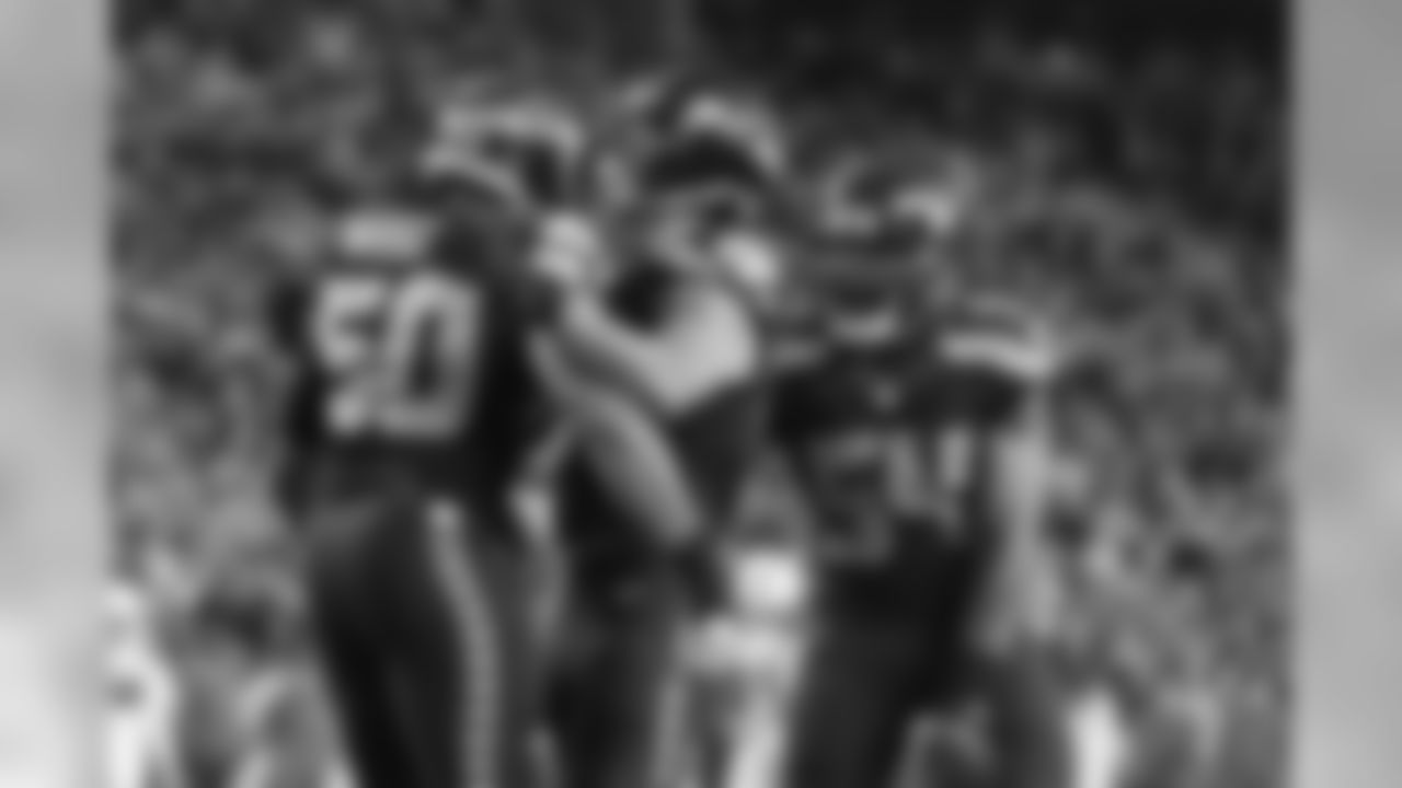 Seattle defenders K.J. Wright, Cassius Marsh and Bobby Wagner celebrate a stop.
