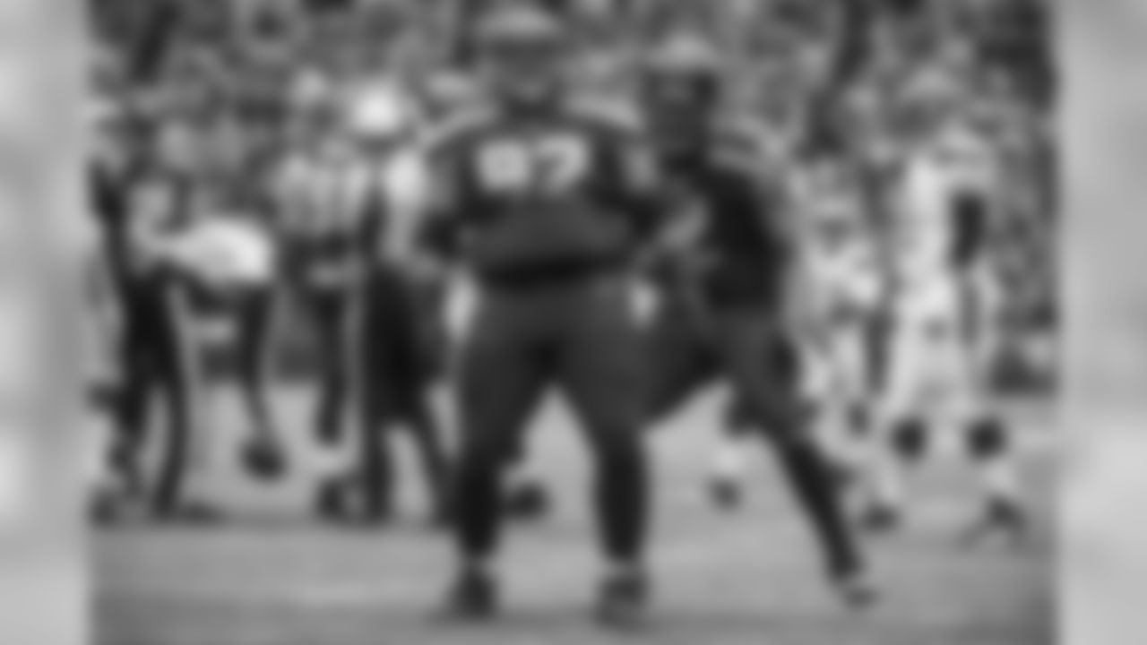 Seahawks defensive lineman Brandon Mebane reacts to his sack by breaking out his signature "belly roll" as teammate Michael Bennett joins the celebration.