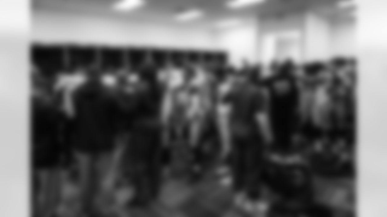 After listening to a talk from head coach Pete Carroll, the Seahawks players gather in the locker room.