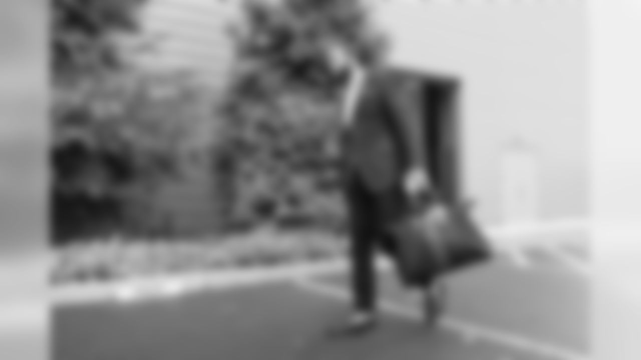 Michael Bennett is once again resplesdent in a blazer and slacks, his outfit made even more distinctive by his pocket square and sockless shoes with blue soles.