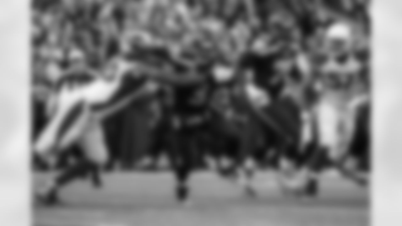 Seahawks quarterback Russell Wilson tries to escape a swarm of Arizona defenders, but is tackled for a loss by the Cardinals' Calais Campbell. Wilson was sacked seven times by the Cardinals defense.
