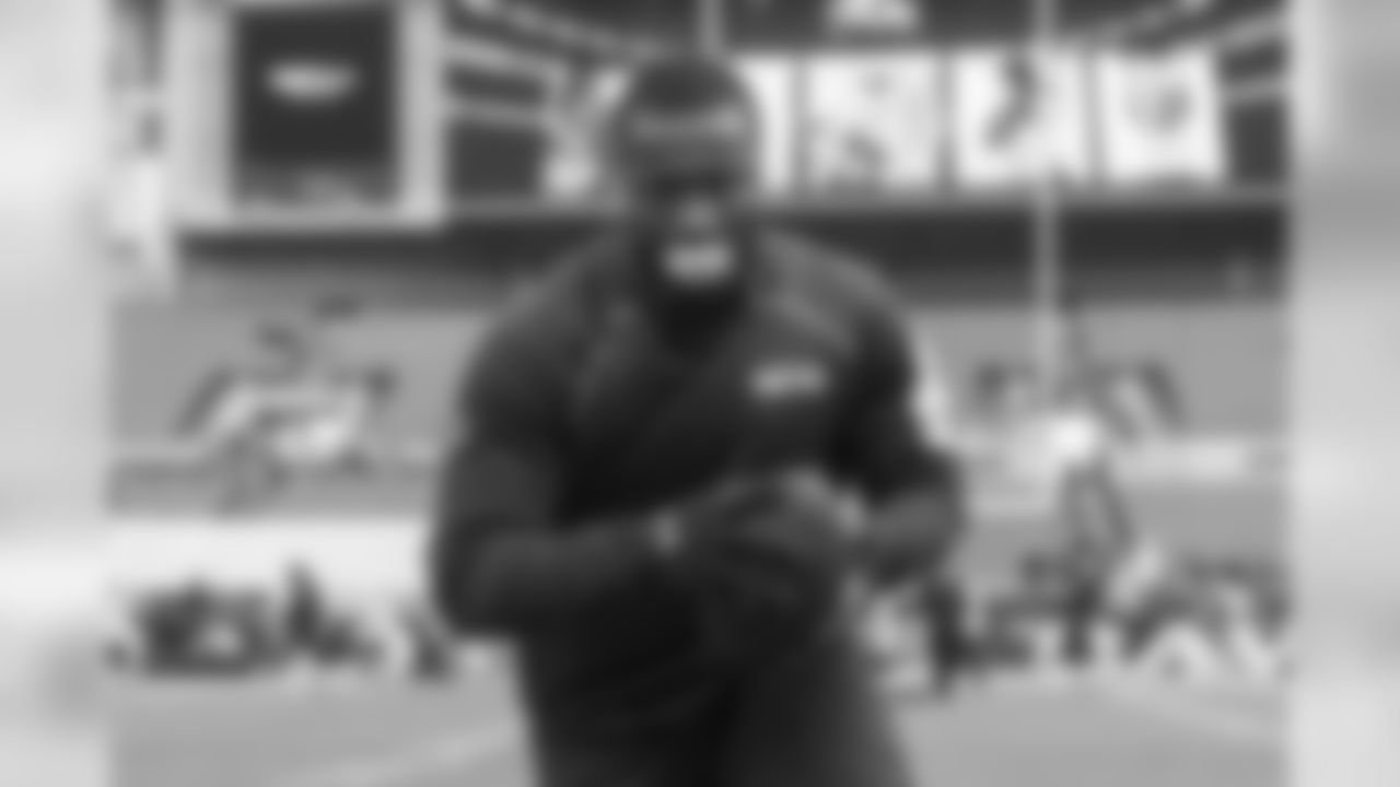 Linebacker Kevin Pierre-Louis, sporting his distinctive mouth guard, warms up before the game.