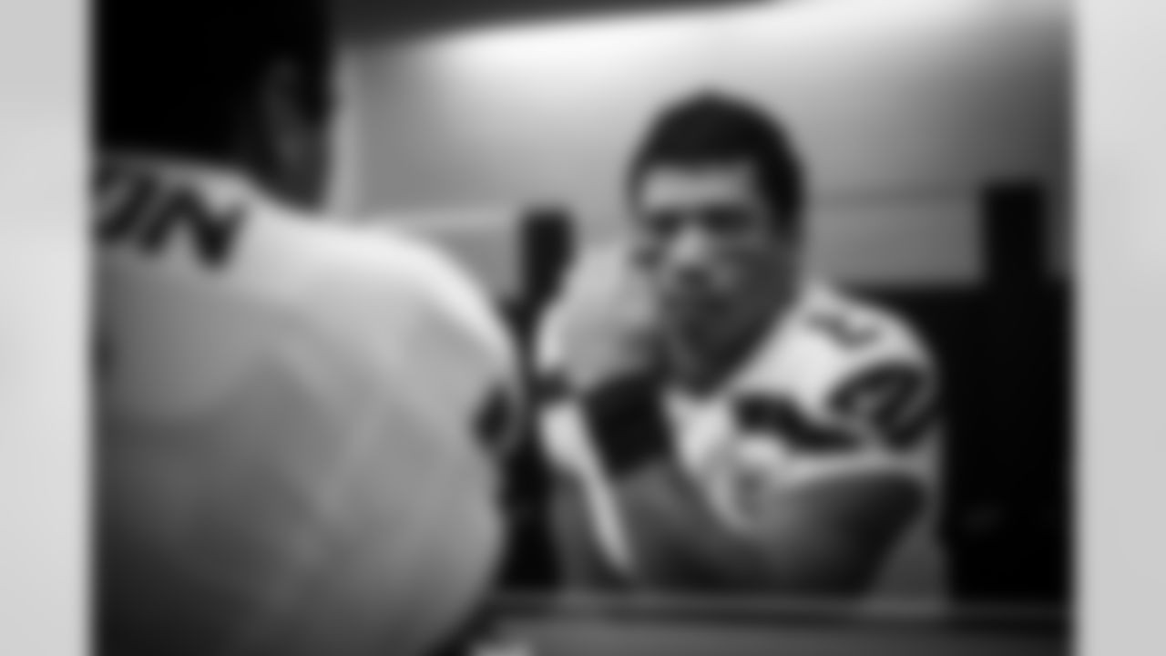 Quarterback Russell Wilson applies eye black before taking the field.