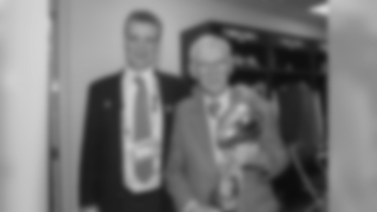 Dan Rooney poses for a photo with his son Art Rooney II in the locker room with the Lombardi trophy after winning Super Bowl XL.