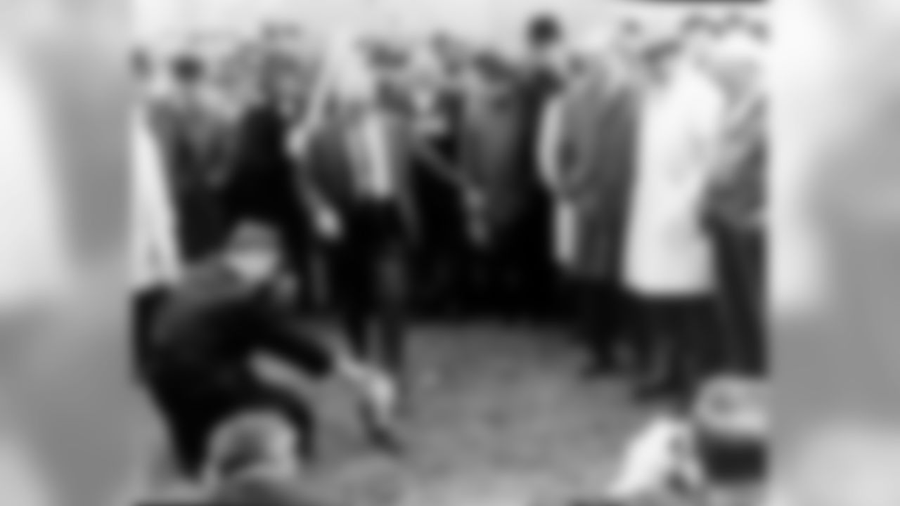 Dan Rooney holds the ball for his father Art Rooney to kick during the 1968 groundbreaking ceremony for Three Rivers Stadium.
