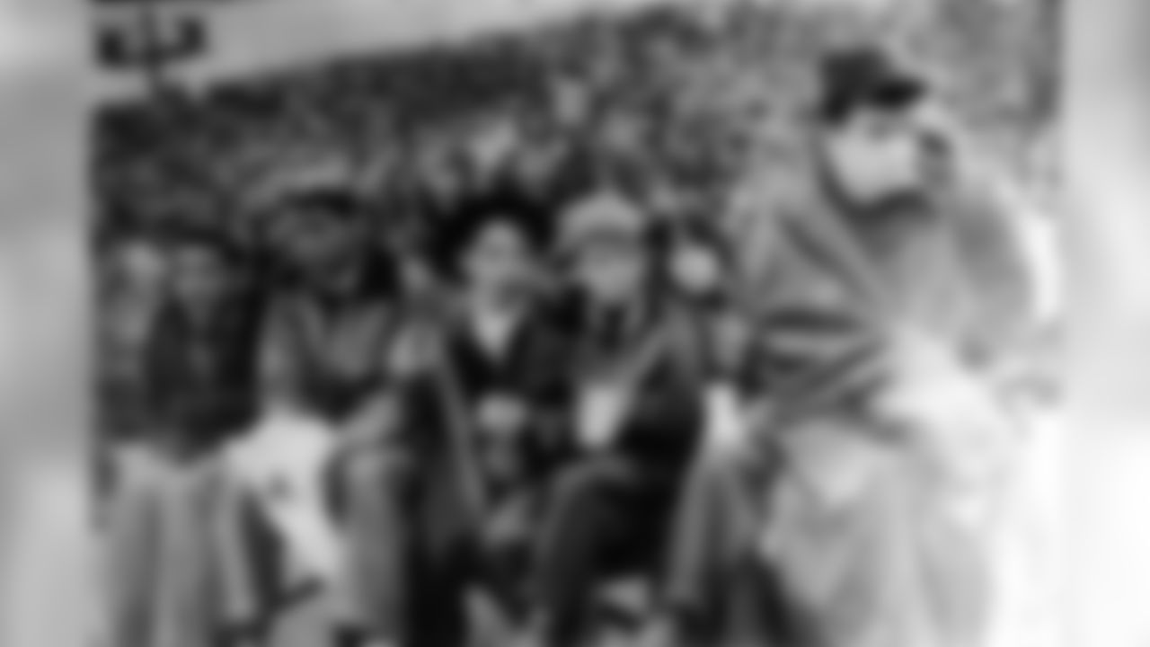 Dan Rooney, pictured far right, sits on the bench as a ball boy.