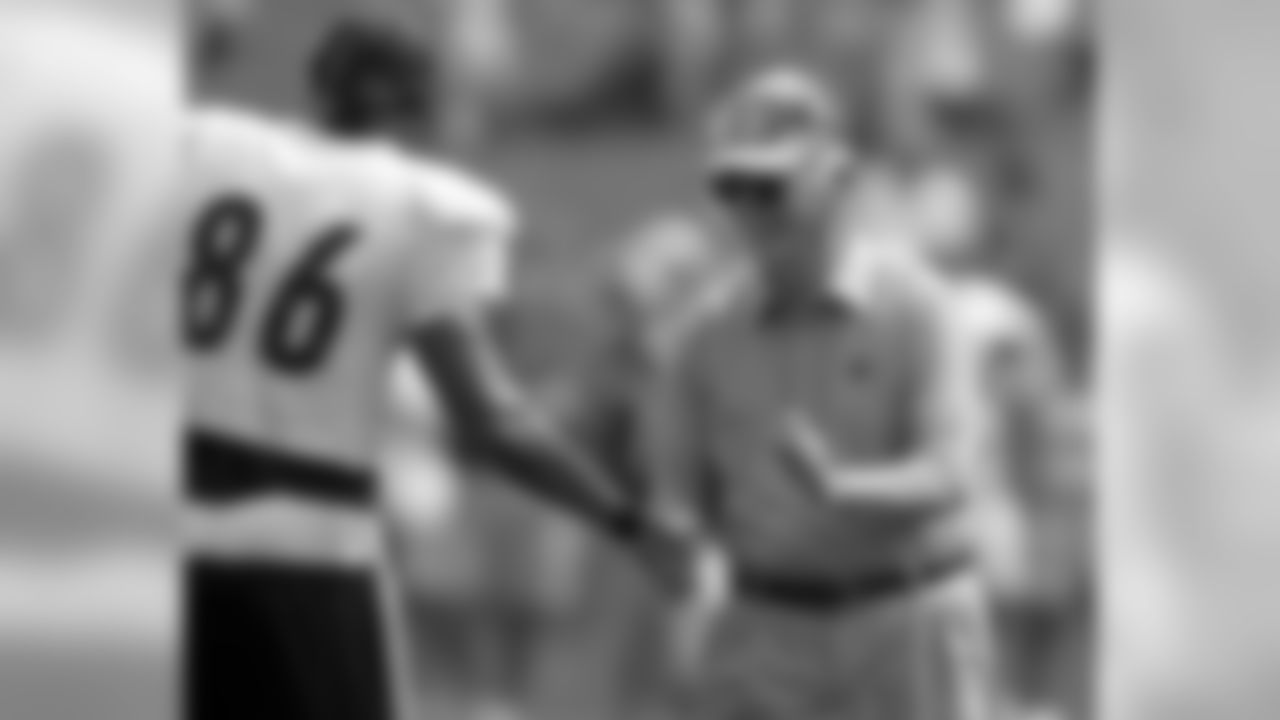 Dan Rooney Shakes hands with Hines Ward.