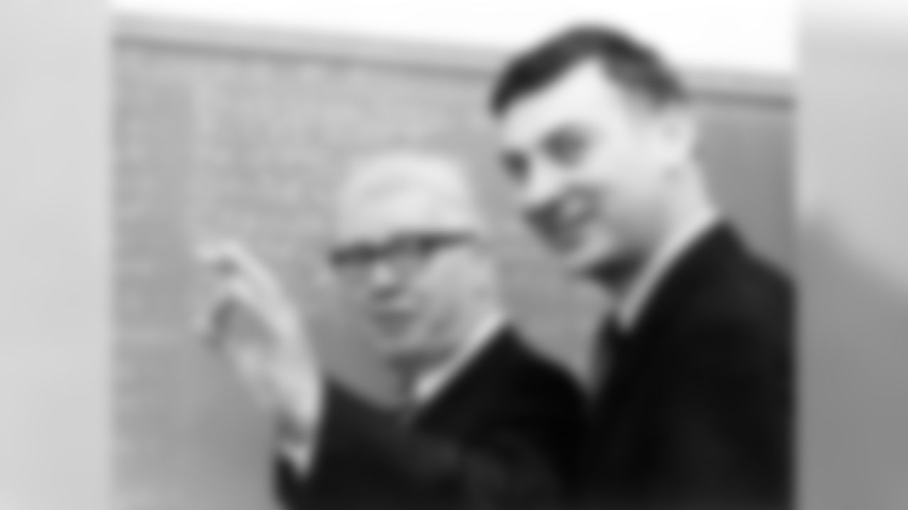 Art Rooney and Dan Rooney stand at a chalk board discussing the Draft.