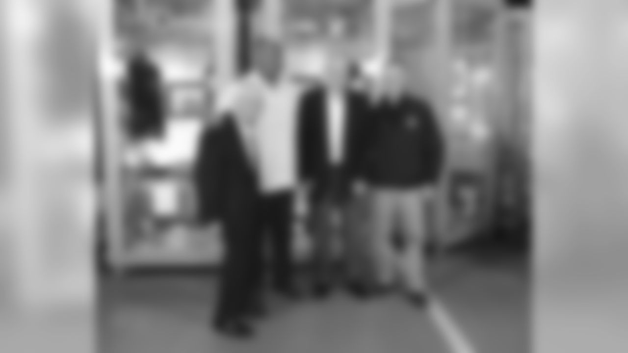 Dan Rooney stands with Dermontti Dawson, Jack Butler and Art Rooney II during a locker unveiling for the newest members to the Pro Football Hall of Fame.