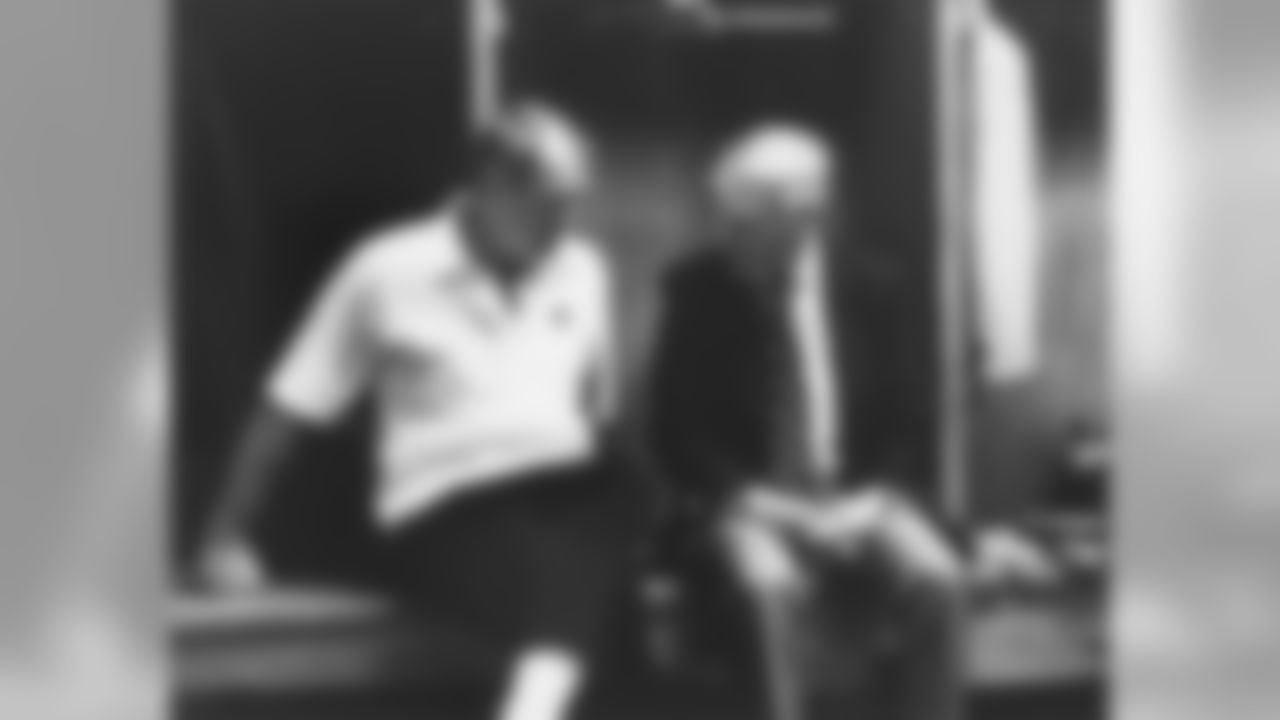 Candid shot of Steelers owner Dan Rooney sitting with Steelers head coach Chuck Noll in the locker room after the Dallas Cowboys defeated the Steelers.