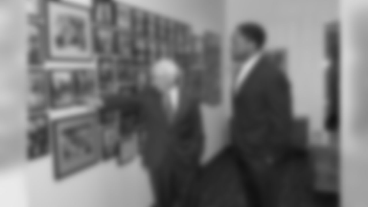 Dan Rooney shows Head Coach Mike Tomlin some historical photographs after signing him to the Head Coaching position.