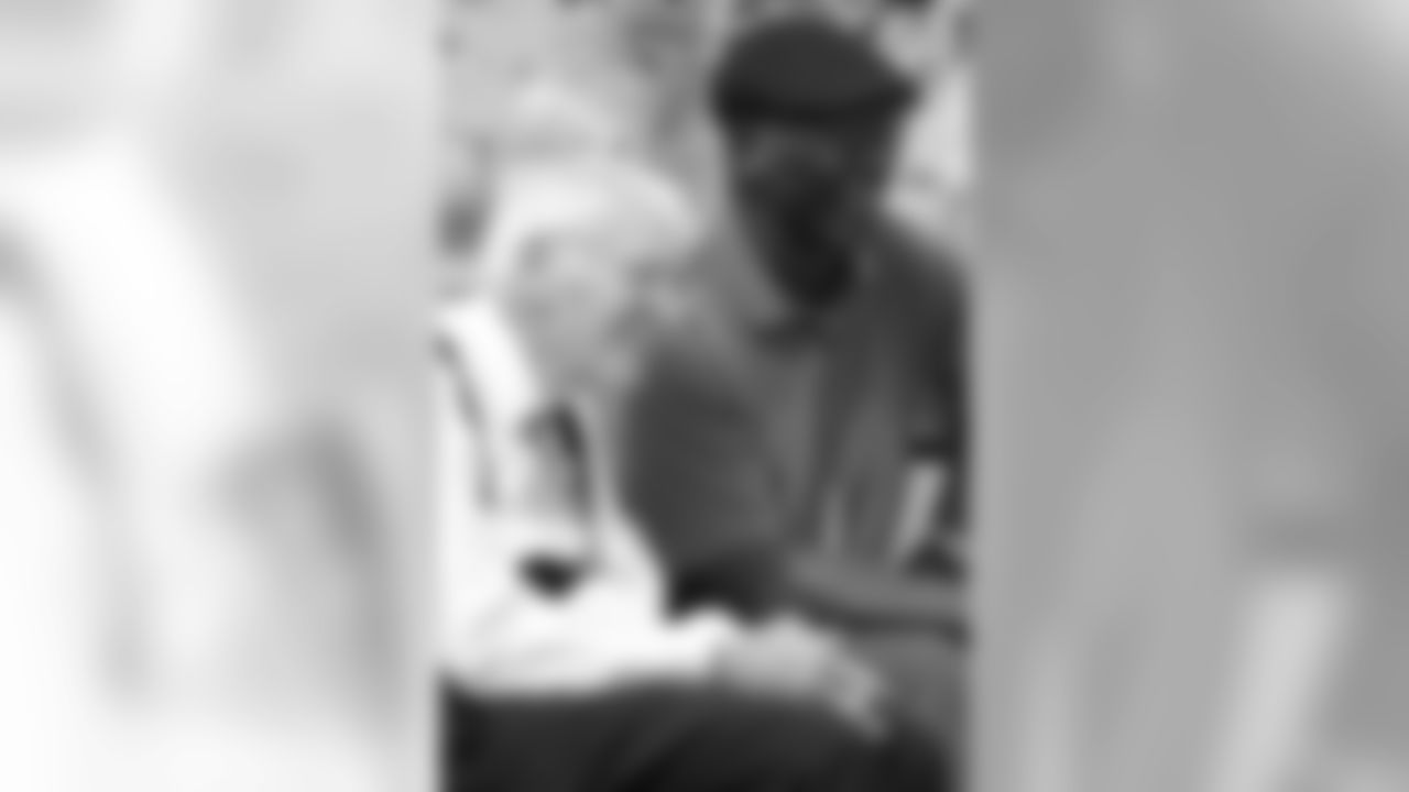 Dan Rooney talks with John Stallworth.