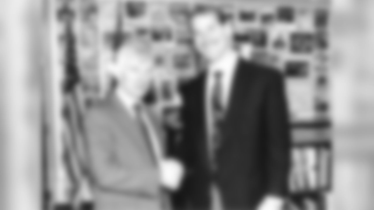 Dan Rooney poses for a photo with Bill Cowher after signing him to the Steelers head coaching position.