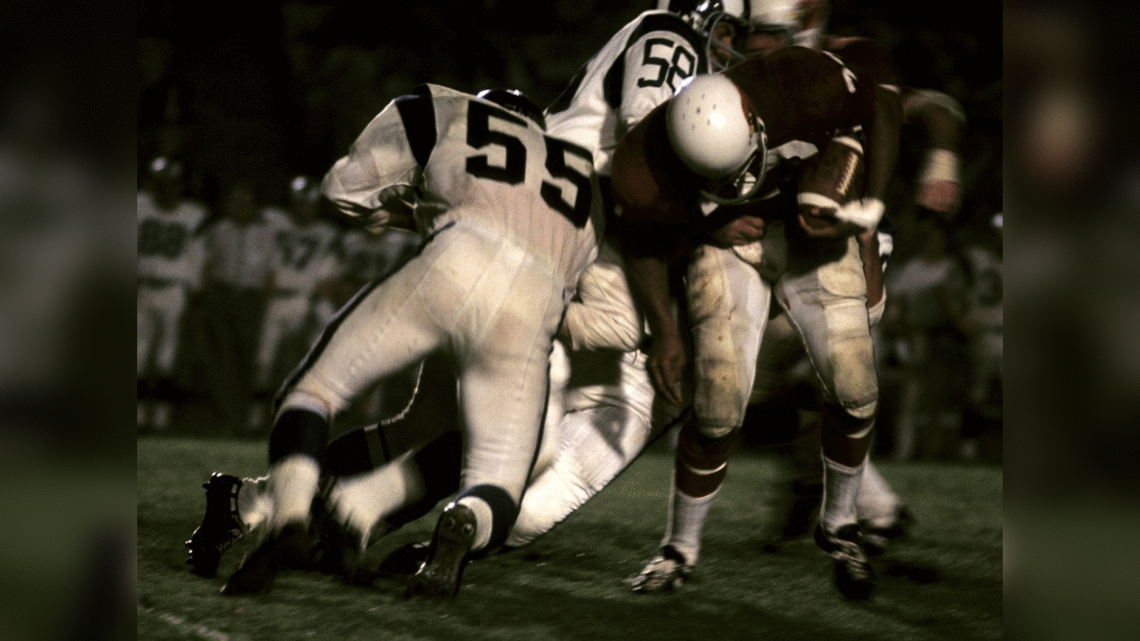 1966: Cardinals RB Johny Roland is tackled by Rams LB Dan Currie