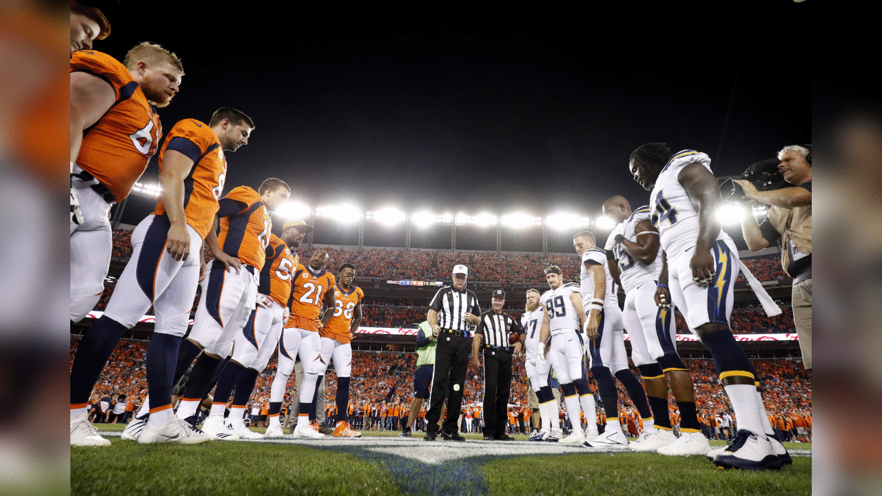 The Denver Broncos and the Los Angeles Chargers stand at mid field for the coin toss prior to an NFL football game, Monday, Sept. 11, 2017, in Denver. (AP Photo/Jack Dempsey)