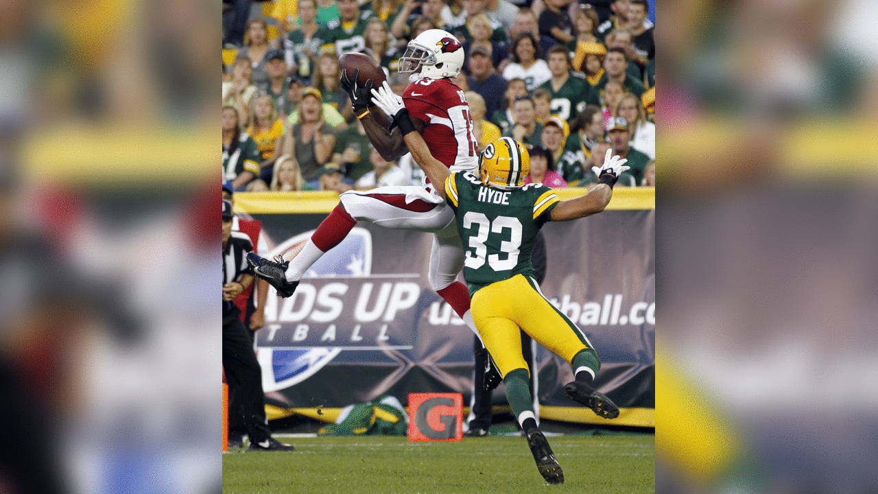 Arizona Cardinals' Jaron Brown catches a touchdown pass in front of Green Bay Packers' Micah Hyde (33) during the first half of a preseason NFL football game Friday, Aug. 9, 2013, in Green Bay, Wis. (AP Photo/Mike Roemer)