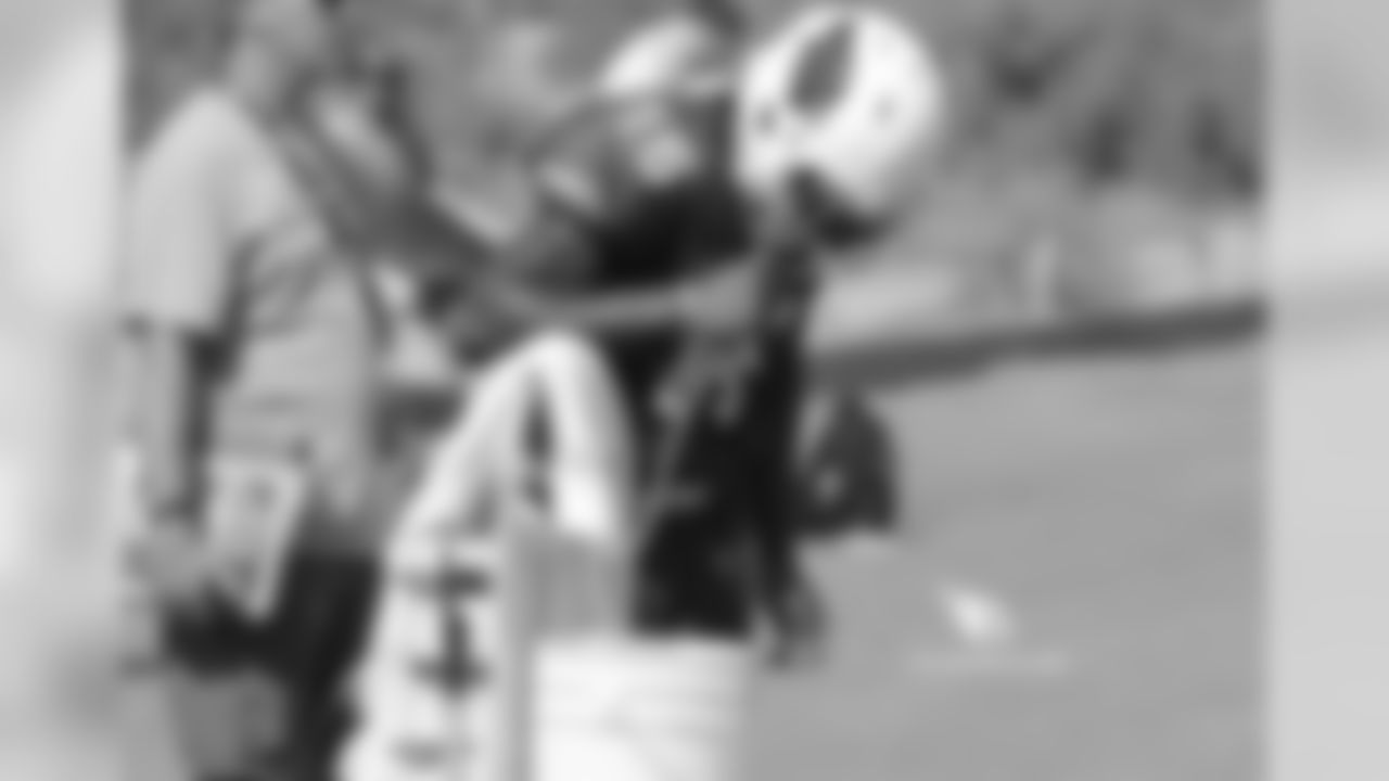 Day 9: WR Chad Williams hydrates during a break in the action
