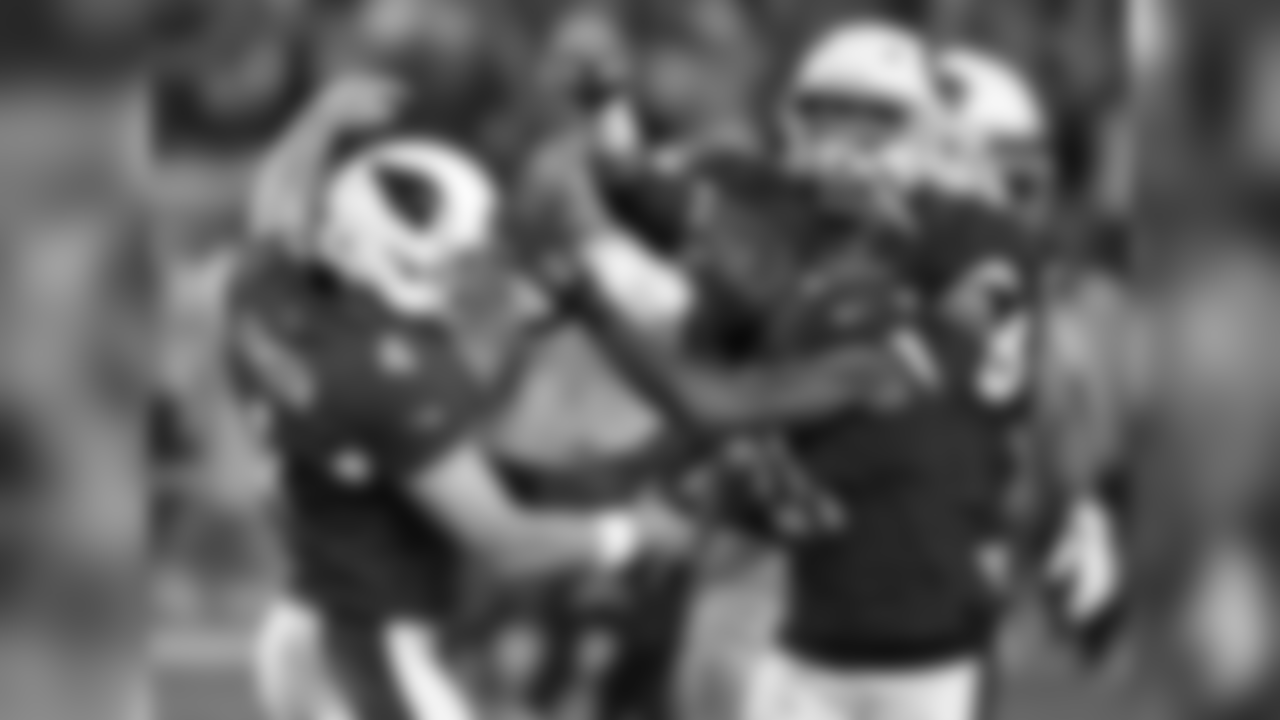 Phil Dawson (left) celebrates with Patrick Peterson (right) after hitting the game-winning field goal