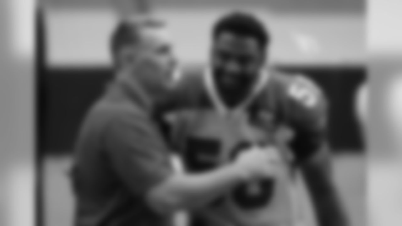 Day 12: Hall of Fame quarterback Kurt Warner (left) hugs LB Karlos Dansby