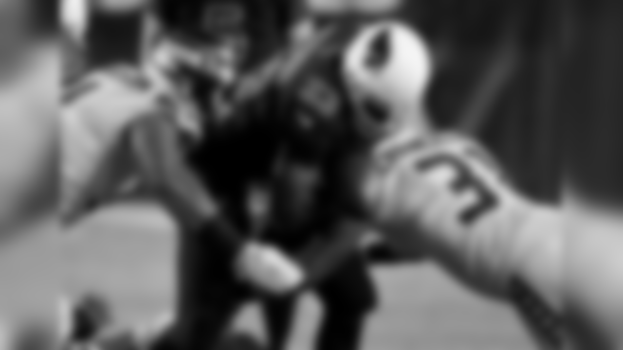 Seahawks S Kam Chancellor knocks the ball loose from Cardinals RB Adrian Peterson