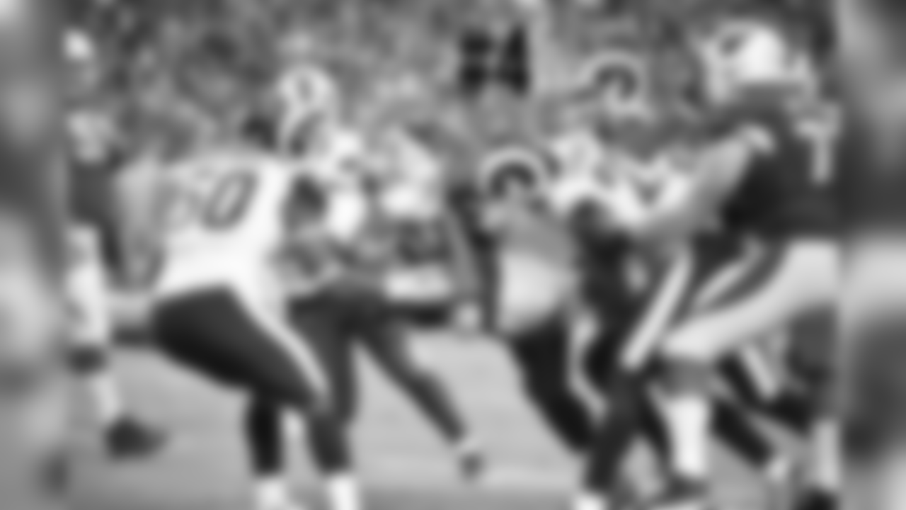 WR Larry Fitzgerald is grabbed by multiple Rams defenders