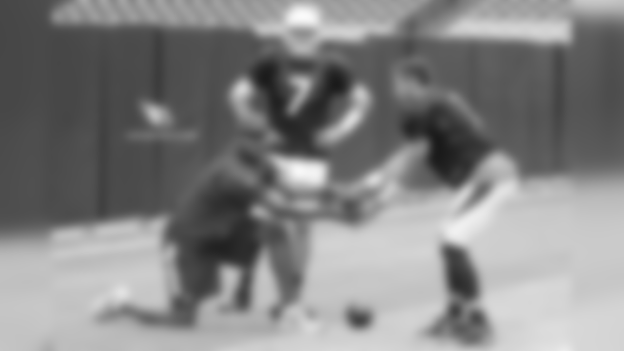 QB coach Byron Leftwich snaps the ball to QB Trevor Knight