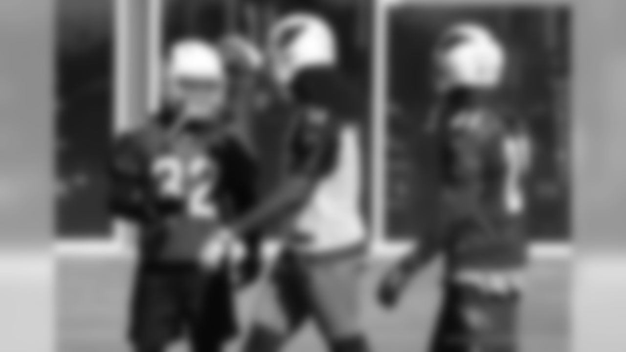 WR Larry Fitzgerald (center) gives S Tyrann Mathieu some love after a nice play in coverage