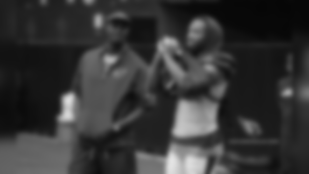 Coaching intern Plaxico Burress and WR Larry Fitzgerald